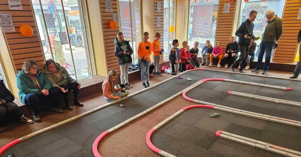 Kinderen leren Mini-Z rijden op een tijdelijke baan tijdens Koningsdag