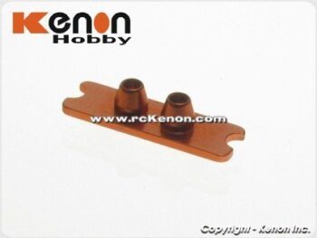De foto toont een oranjekleurig metalen onderdeel met een langwerpige, platte basis en twee conische uitsteeksels. Het lijkt een onderdeel voor een modelauto te zijn.
