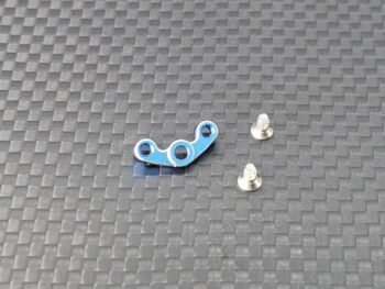 De foto toont een blauw metalen onderdeel met drie gaten en twee zilverkleurige schroeven. Het onderdeel heeft een onregelmatige vorm.