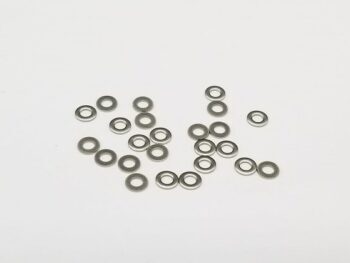 De foto toont een verzameling van ongeveer 30 kleine, ronde, zilverkleurige metalen ringetjes, verspreid over een witte achtergrond. Ze hebben een glanzende, metaalachtige textuur en zijn allemaal van dezelfde vorm en grootte.