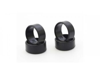The photograph shows four black, round rubber tyres, stacked in two pairs. They have a smooth surface and appear to be intended for model cars.