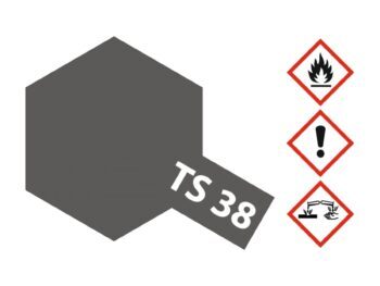 De afbeelding toont een donkergrijze zeshoek met een schuin geplaatste donkergrijze rechthoek met de tekst 'TS 38' in wit. Rechts staan drie gevaarsymbolen: een vlam, een uitroepteken en een symbool voor corrosie.