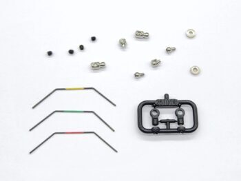 De afbeelding toont een set RC-onderdelen, waaronder drie anti-roll bars met gekleurde markeringen (geel, groen, rood) en diverse metalen schroeven, kogels en lagers. Er is ook een zwart plastic frame met twee bevestigingspunten.