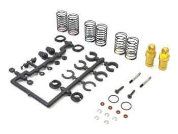 The image shows a set of parts for shock absorbers, including gold shock absorbers, black springs, a black plastic sprue with various parts, and small metal and rubber parts.