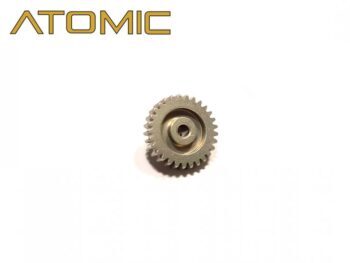 La foto muestra una pequeña rueda dentada metálica redonda de color plateado con dientes finos en el borde exterior y una abertura central. En la parte superior de la imagen aparece el logotipo «ATOMIC» en letras doradas.