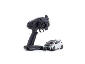 De afbeelding toont een witte miniatuurauto met zwarte accenten en een zwarte afstandsbediening ernaast, op een witte achtergrond. De auto heeft een sportief uiterlijk met een dakrek.
