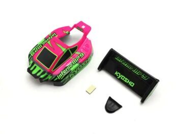The image shows a pink and green painted Lexan body for an RC buggy, along with a black rear wing and a small black part. The body has 'Inferno MP9' and 'KYOSHO' written in green letters.