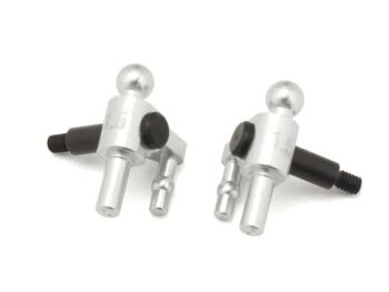 The photograph shows two silver-coloured steering blocks with black screw threads and black details. The steering blocks are made of metal and have a complex shape.