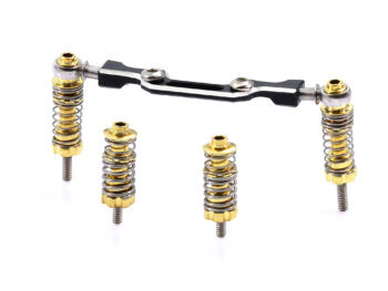 De foto toont een set veerelementen voor een auto, bestaande uit gouden en zilverkleurige onderdelen. De set bevat veren, schroeven en een zwarte verbindingsstang.