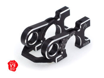 De foto toont twee zwarte metalen onderdelen met zilveren accenten. De onderdelen hebben een complexe vorm met gaten en een schaalverdeling.