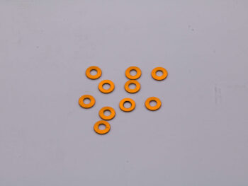De foto toont een aantal oranje ringen. De ringen lijken van metaal te zijn.