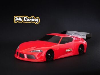 Das Foto zeigt eine rote, unlackierte Karosserie eines Autos. Die Karosserie hat einen Spoiler und ist aus Lexan gefertigt.