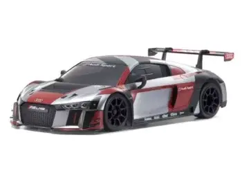 De foto toont een modelauto van een Audi R8 LMS in een combinatie van rood, grijs en zwart. De auto heeft een spoiler en is duidelijk een model van een raceauto.
