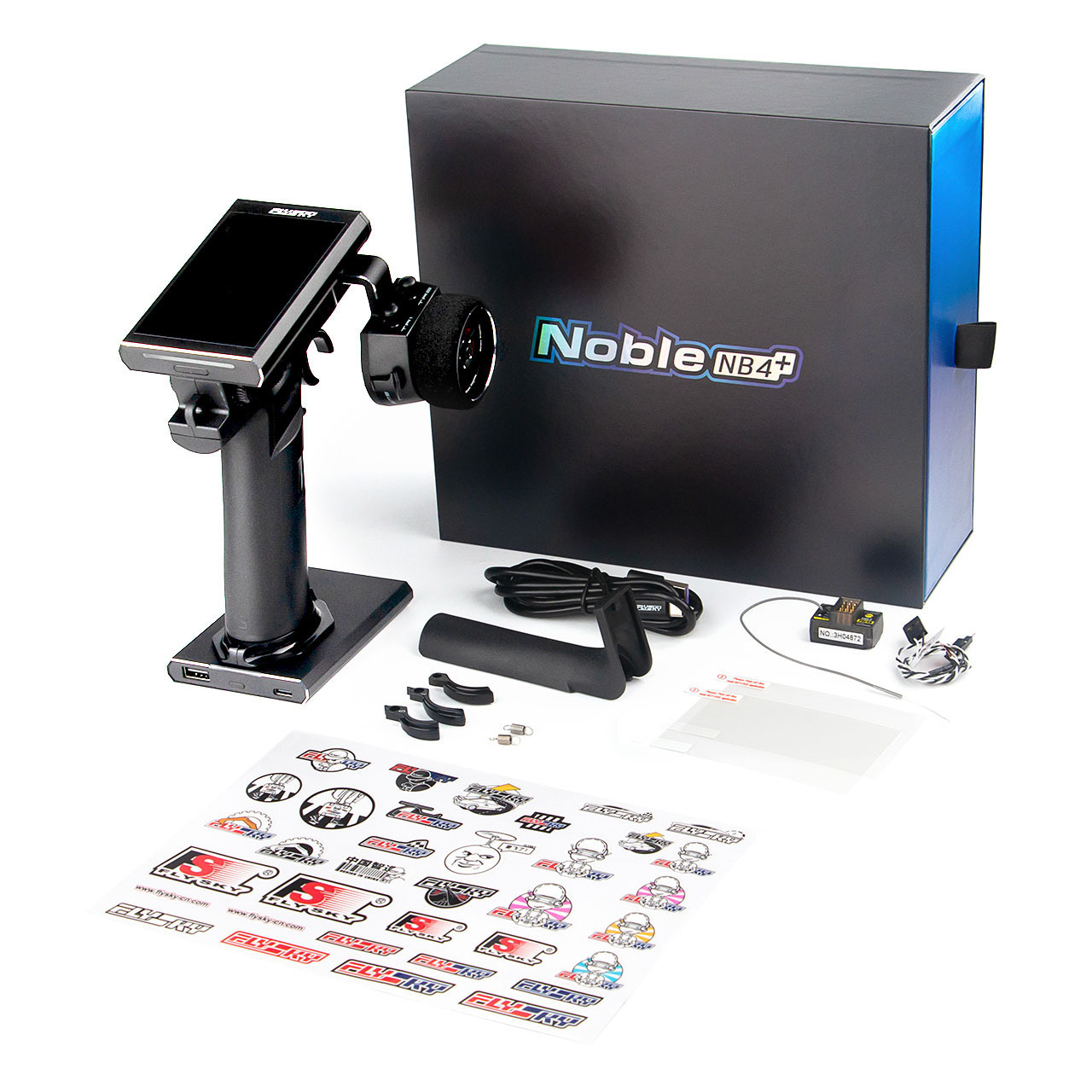 De foto toont een zwarte RC-zender met een touchscreen en een bijbehorende ontvanger, kabels en stickers. Er is ook een zwarte doos met de tekst 'Noble NB4+' erop.