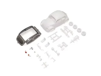 Witte plastic onderdelen van een Volkswagen Kever modelbouwset, inclusief carrosserie, ramen en wielen.